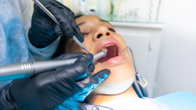 Person in dental chair with dentist