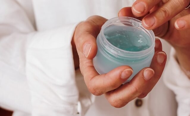 dentist holding jar of gel