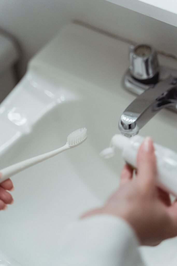 person using toothbrush and paste