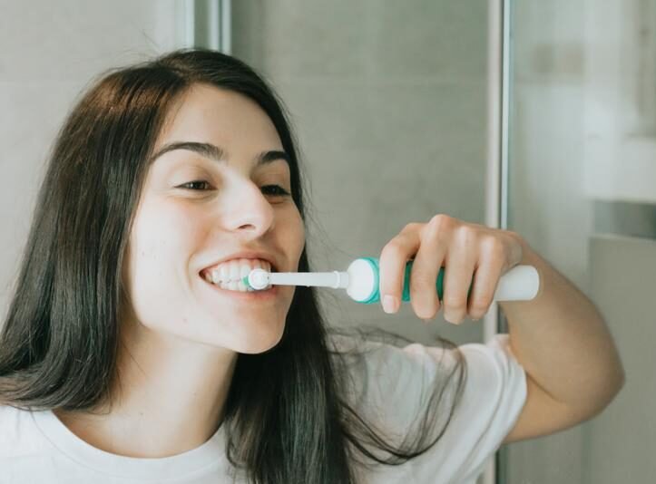 Woman brushes teeth with brush