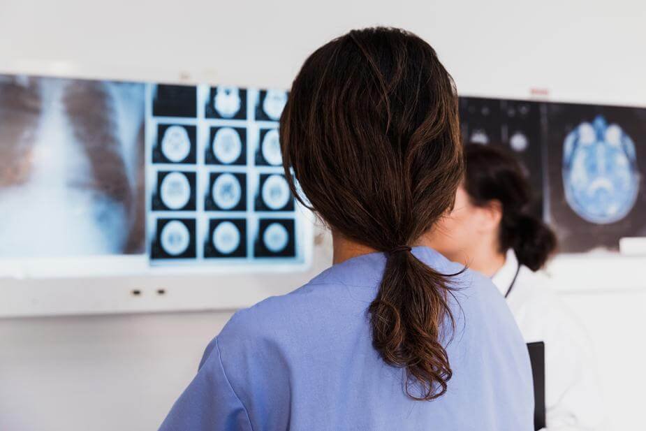 patient and dentist with x-rays