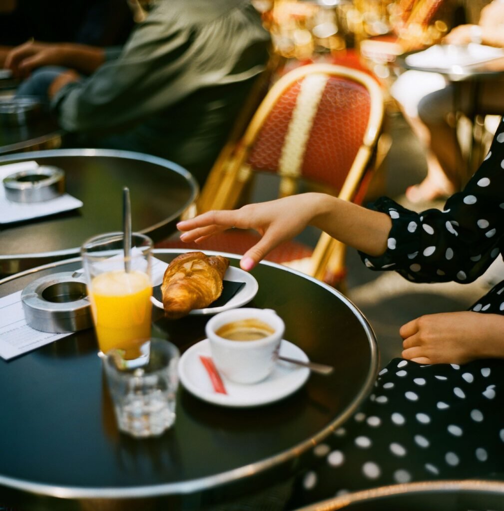 person grabbing croissant