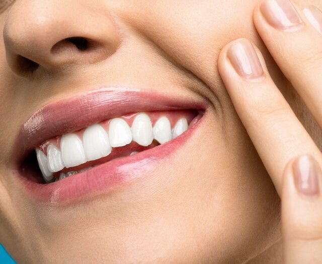 Woman smiling touching cheek